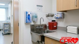 Medical station with needle stick disposal and first aid supplies.