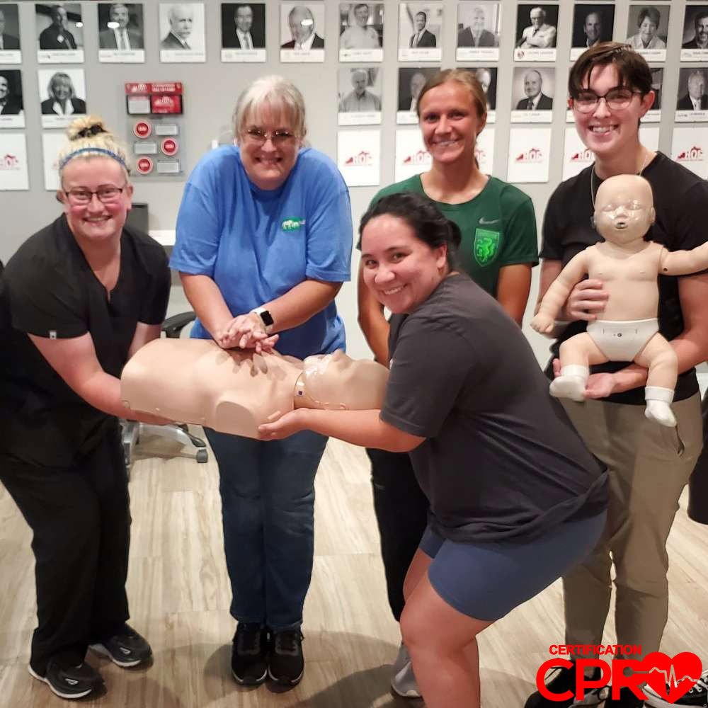 CPR training class in Clearwater with students practicing on mannequins.